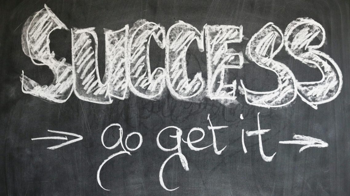 Success "Chalkboard with the words 'SUCCESS' and 'go get it' in decorative white lettering."